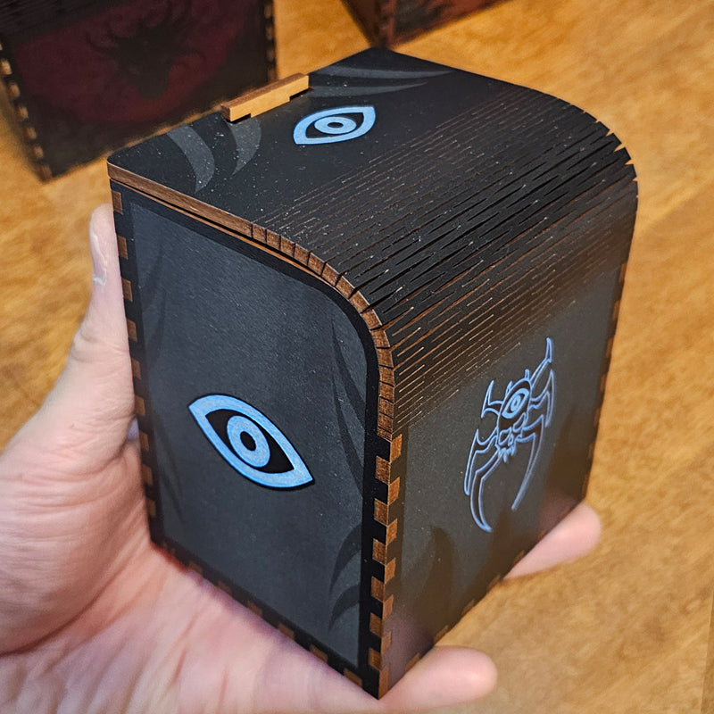 Black laser cut card deck box with skull and third eye motifs and waffle flex technology to allow the box to open.